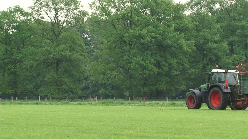 Farmer spreading organic manure over small land parcel. Organic agriculture is a production system that sustains the health of soils, ecosystems and people.