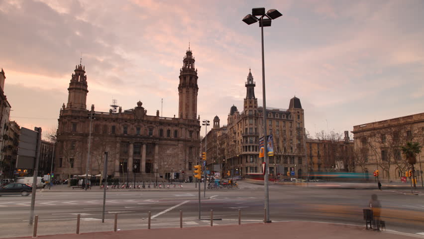 early evening shot in barcelona of road crossing infront of the main post office building