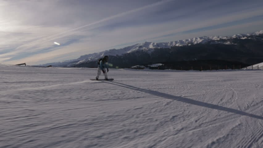 Snowboarder slides on the snow slope