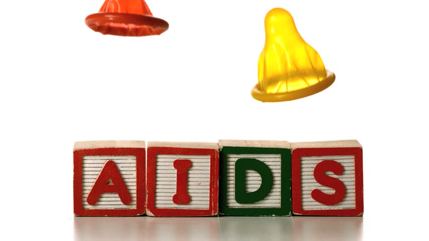 Condom falling on blocks spelling AIDS in slow motion