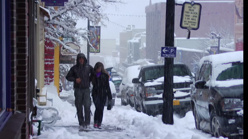 PARK CITY, UTAH - CIRCA 2010: tourists walk through heavy snow 