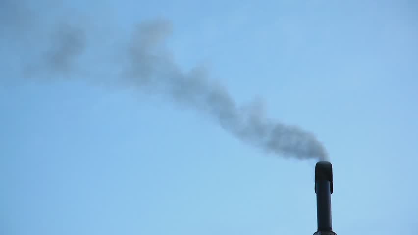 Smoke coming out from a black chimney