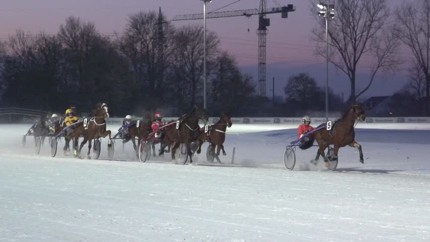 MUNICH - FEBRUARY 10: (Slow motion) Riders compete in trotting event at Sunday Race at Daglfing Racetrack in Munich, Germany on February 10, 2013.