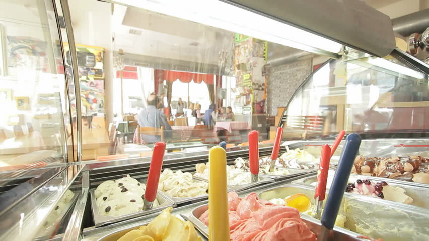 looking at a coffee shop interior through an ice cream display window