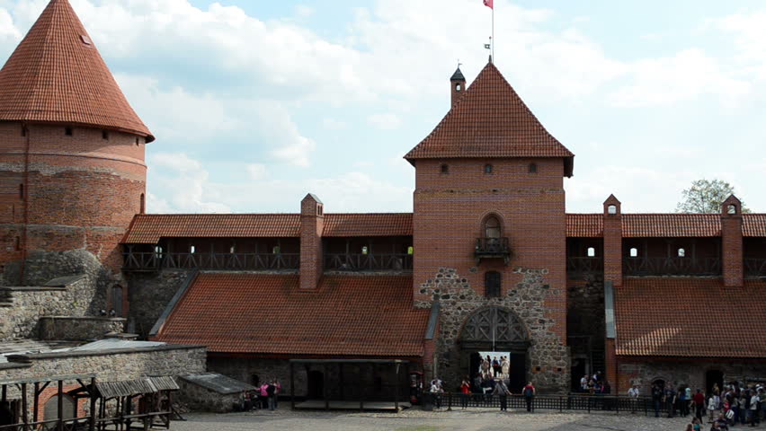 Tourist people in ancient Trakai castle yard and Galve lake.