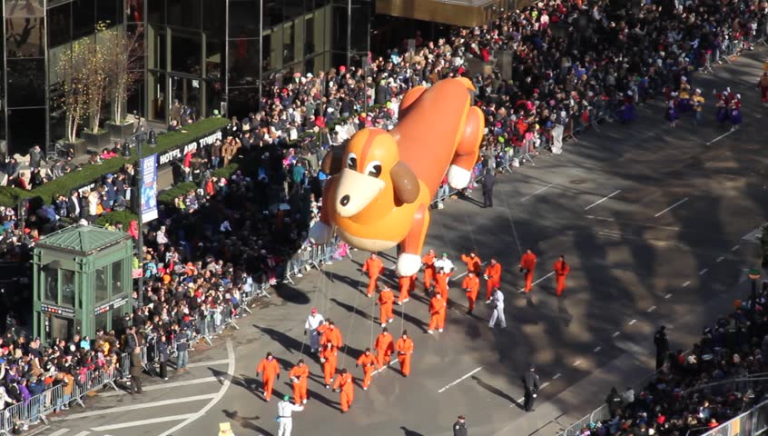 New York, NY - Circa 2011: Dachshund, wiener dog balloon in Macy's Thanksgiving Parade floating down the street in front of hundreds of spectators 