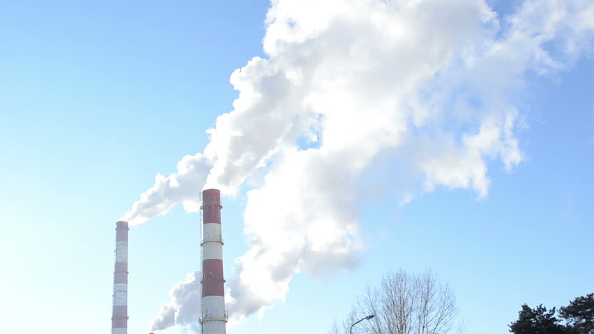 white smoke vapour rise from industrial factory chimneys on background of blue sky. boiler-house heating all city houses in winter.