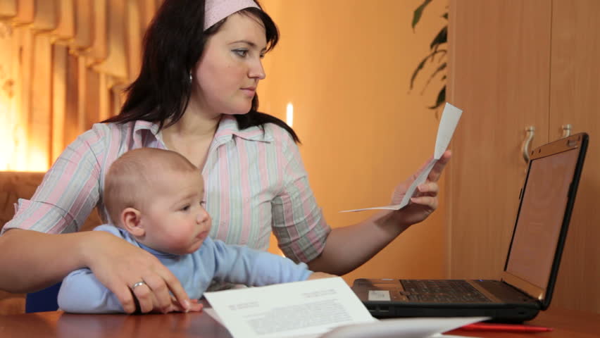 Housewife at home reading some financial notice