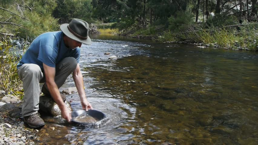 a prospector pans for gold at Sofala in Australia