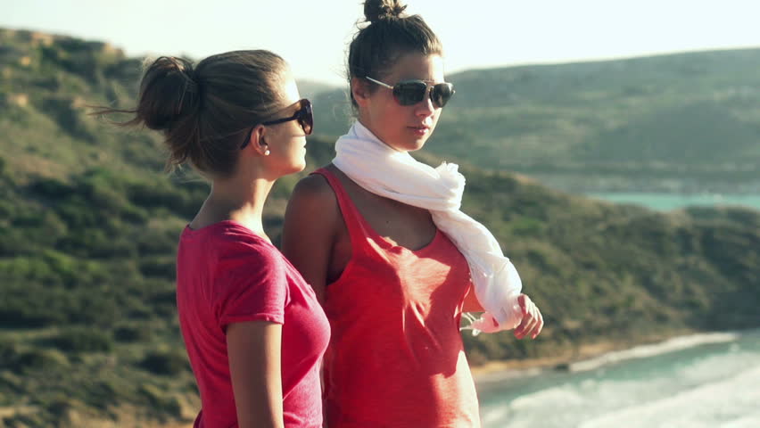 Female friends standing on the view point and looking at the sea, slow motion shot at 240fps
