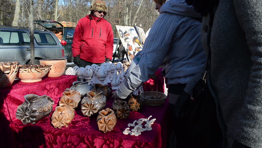 VILNIUS, LITHUANIA - MARCH 02: Seller sell different crockery clay handmade objects decorations in outdoor spring fair market festival on March 02, 2012 in Vilnius.