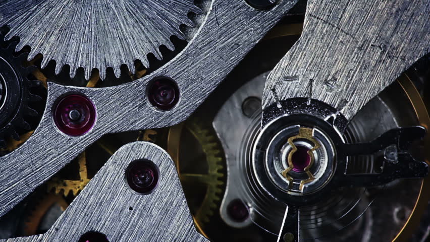 The pendulum and gears of the old watch on the move. Close-up. The focus in the foreground