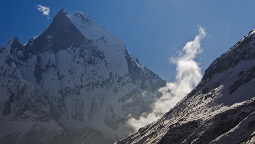Clouds forming near the Machapuchare peak in the Annapurna region of the Himalayas on the way to the Annapurna Base Camp (time lapse/timelapse)