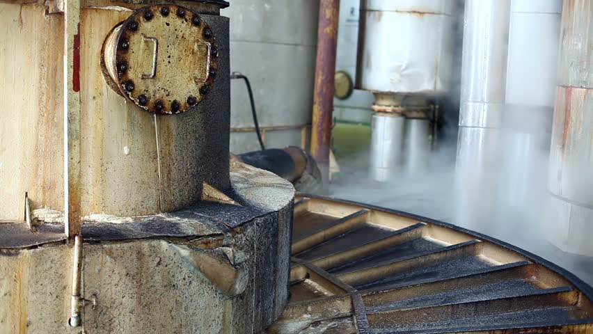 Steam in industrial plants, inside the factory for sugar production. Processing Sugar Beet in Sugar Refinery.