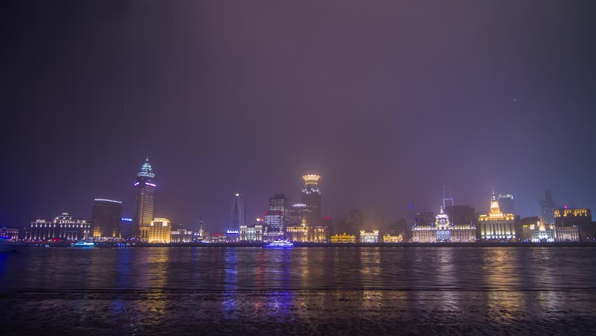 Time Lapse of Boats Traffic across from The Bund with flying lantern in Shanghai, China