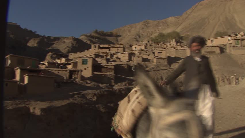 UPPER YAFTAL, AFGHANISTAN - NOVEMBER 23: Children and donkey in a remote mountain village in northeastern Afghanistan on November 23, 2011.