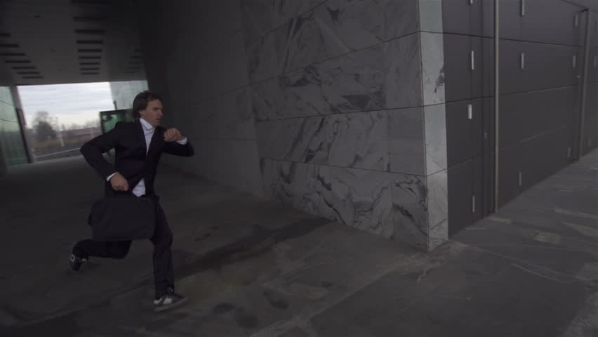 SLOW MOTION: Late businessman is running to a meeting