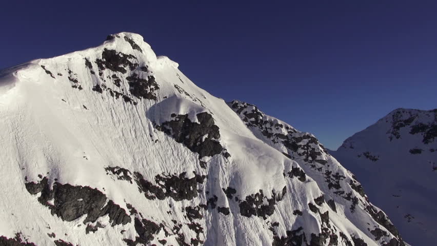flying close away from snow covered mountains