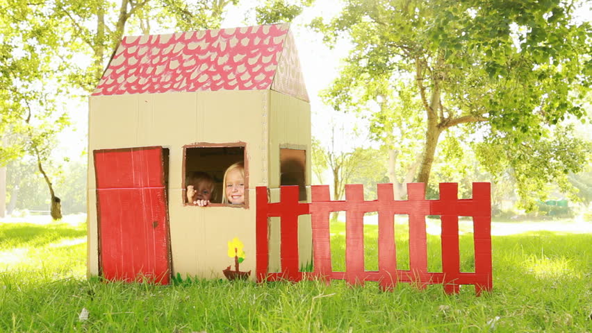 Video of happy little children sitting in playhouse