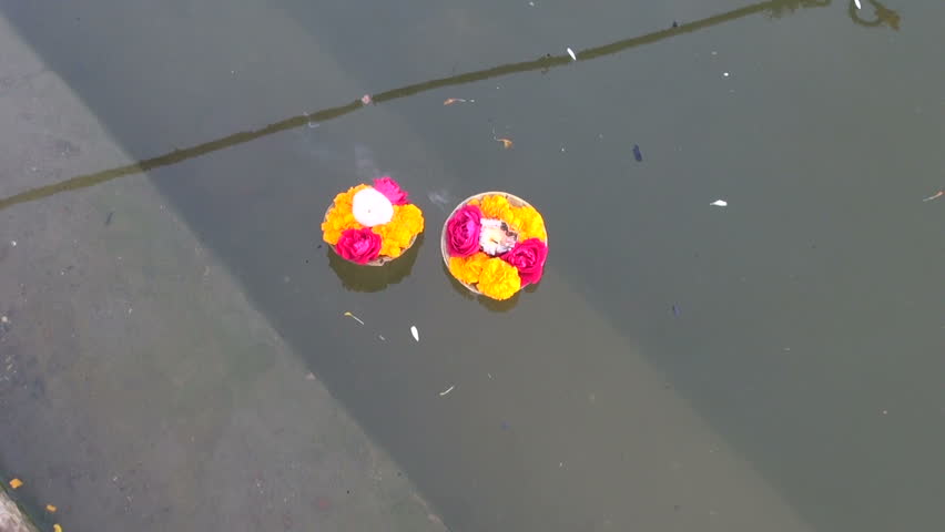 hinduism religious ritual puja flowers and candle on Ganges water, India