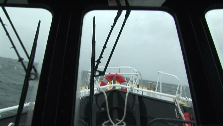 Pilot boat with interior view of waves hitting and spraying windows