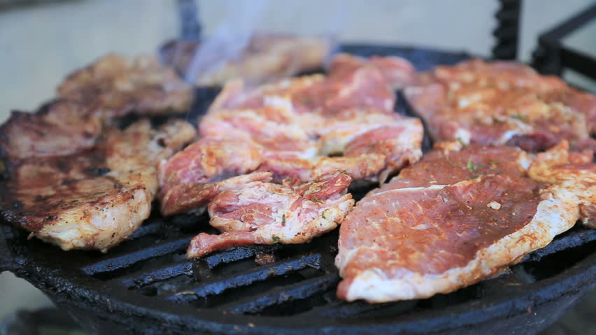 Beef, chicken and pork steaks on barbecue grill