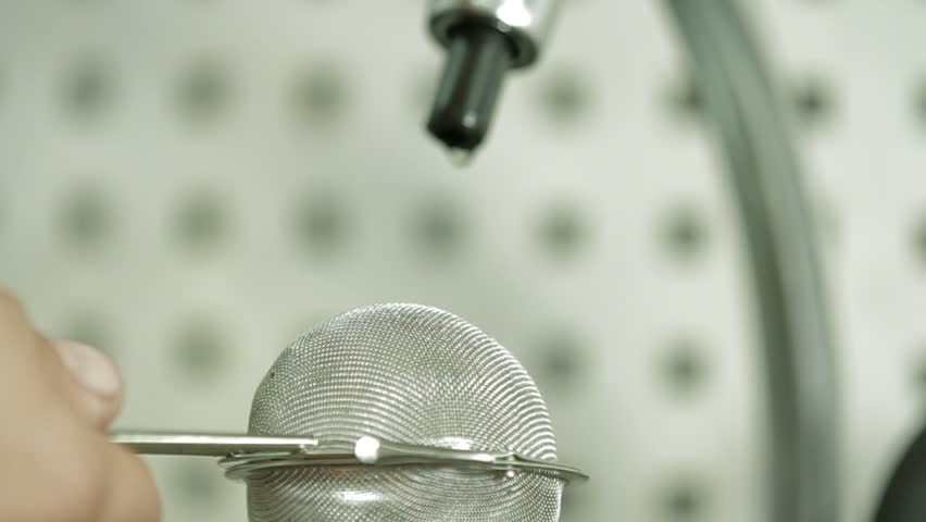 Process of washing machine parts in sieve. Cloe-up. Slow motion.