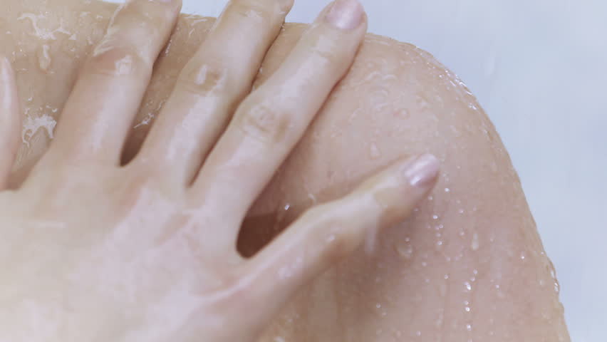 Young woman taking a shower in slow motion