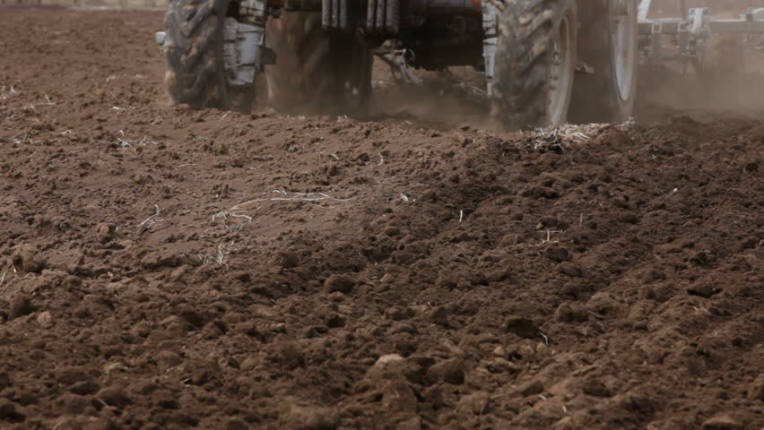 Tractor is plowing farm land.
