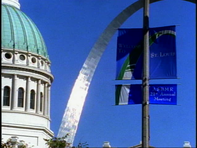 St. Louis Arch, close up with St. Louis City Hall detail and banner welcome to St. Louis
