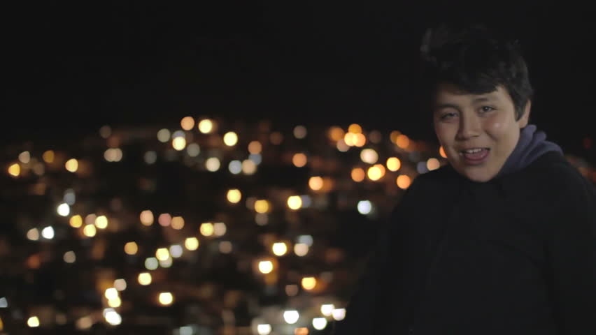 Smiling boy on a panoramic city point at night