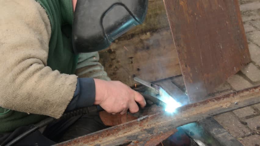 Welder repairing a trailer