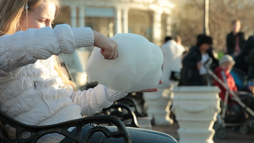 Urban scene - little girl eating cotton candy