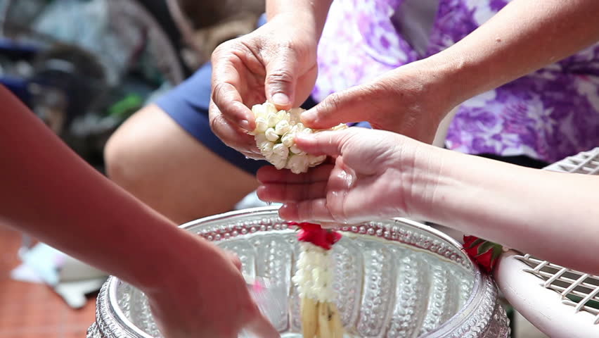 Thai people celebrate Songkran (new year / water festival: 13 April) by giving garlands and pouring water to their seniors and asked for blessings 