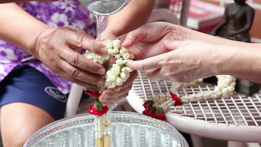 Thai people celebrate Songkran (new year / water festival: 13 April) by giving garlands  and pouring water to their seniors and asked for blessings 