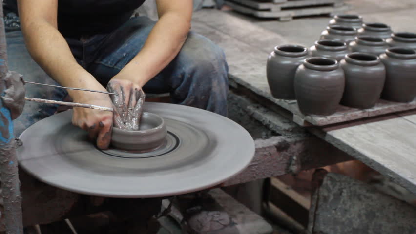 Hands making clay pot