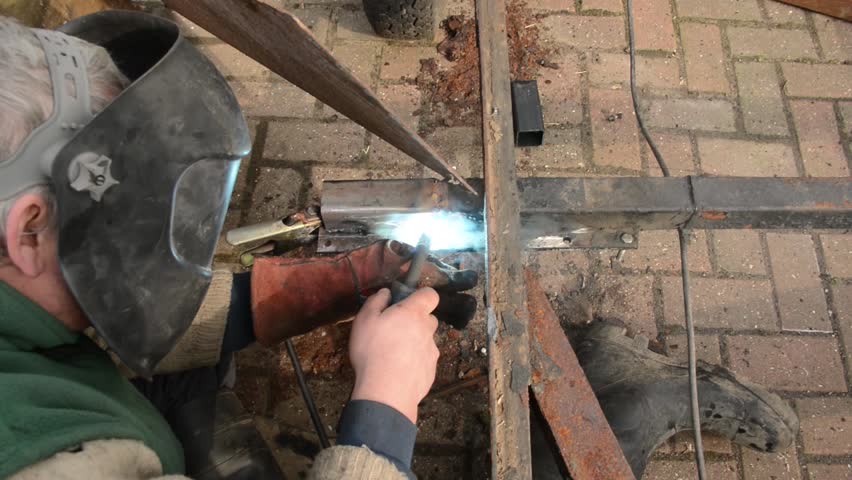 Welder working on a trailer repair