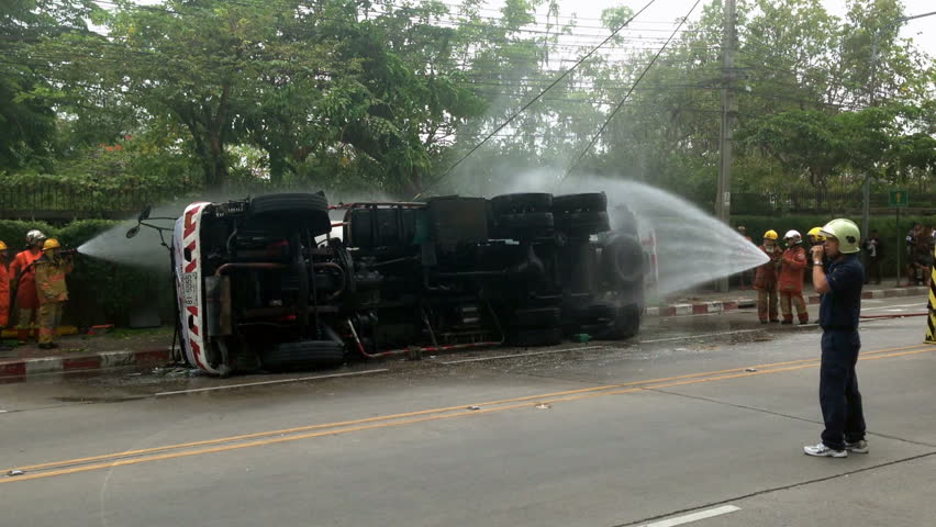 BANGKOK - APRIL 15: A rolled-over gas truck is being craned back on wheel in Bangkok, Thailand, on April 15, 2013. Firemen as watering the truck for safety. The gas truck crashed after a brake failure