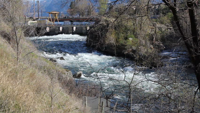 A dam used to control the levels in a nearby lake/Water Levy Dam/A small dam is used to control the water levels in a local lake. 