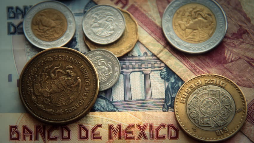 Mexican Pesos 1. Mexican paper and coin currency. Shot at a high frame rate and slowed.