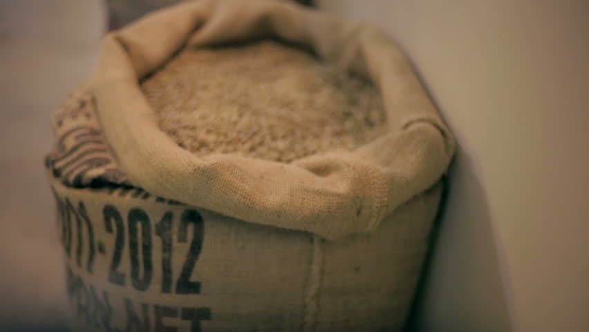 Tracking shot in of raw coffee beans in a sack