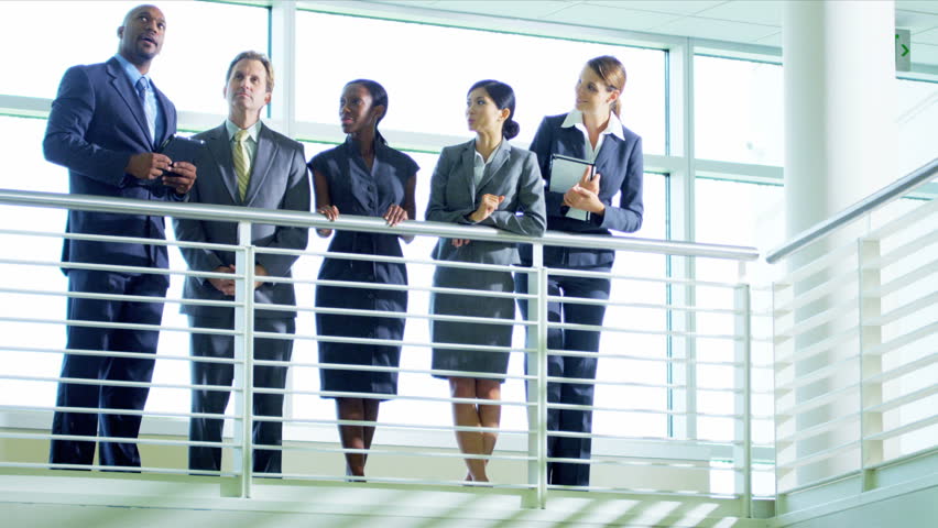 Multi Ethnic business manager discussing with colleagues new office building design layout, shot on Red Epic
