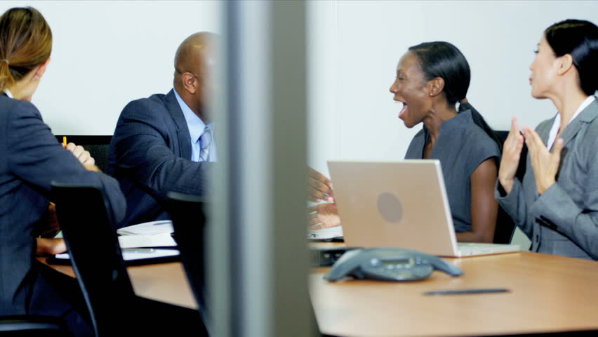 Multi ethnic team financial consultants congratulating each other on team success shot on RED EPIC