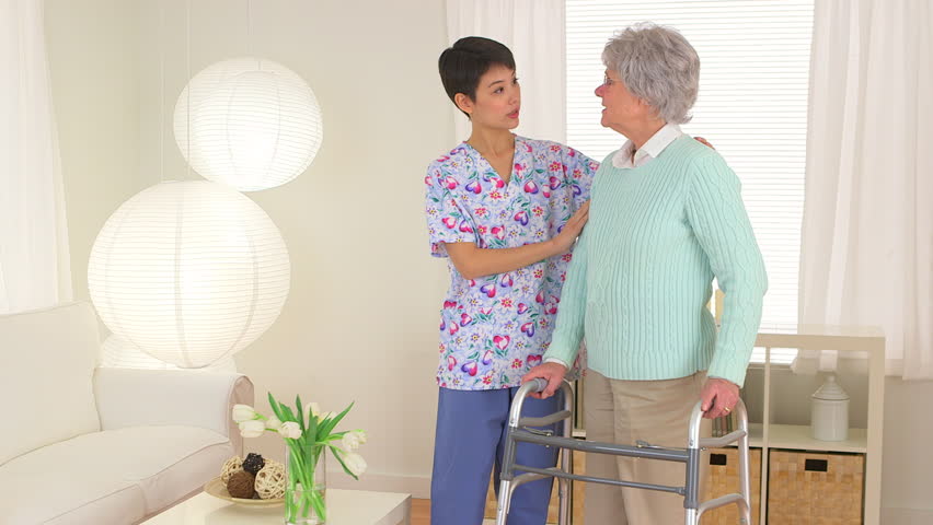 Chinese nurse aiding elderly patient