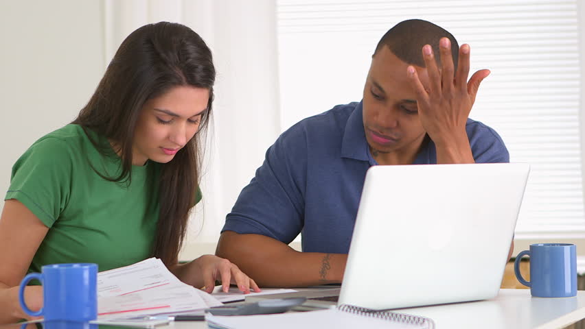 African american and caucasian couple in debt