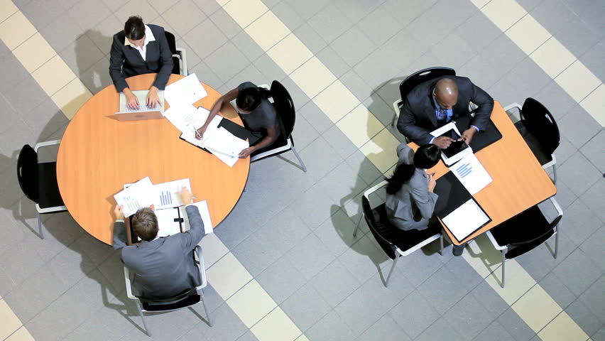 Satisfaction of success by group of multi ethnic business people and clients around table