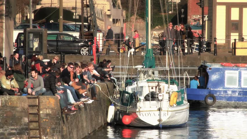 BRISTOL - April 6: People Sitting at Bristol Harbour Side on Sunny Day on April 6, 2013 in Bristol, England.
