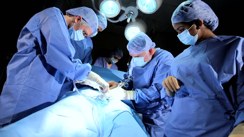 Surgical Team Assisting Male Surgeon Operating Stock Footage Video