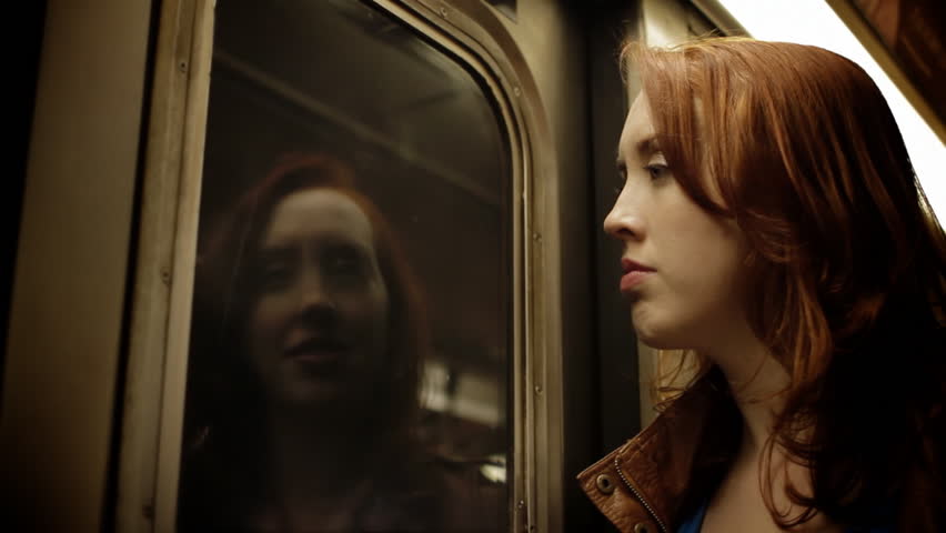 Inner Demon - A woman traveling on a subway train battles her inner demon reflected in the window
