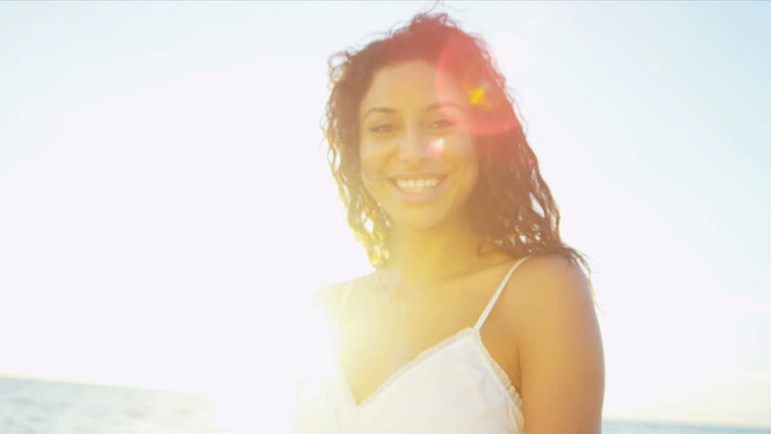 Portrait beautiful Hispanic girl dressed in white smiling to camera sunrise shot on RED EPIC